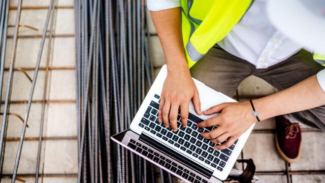 Builder working with a DMS or ERP on the construction site